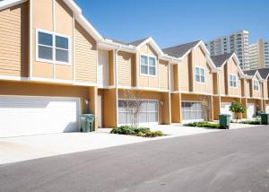 a row of apartment buildings with a driveway at OCEAN VIEW - Retro Arcade - 3 bedrooms in Daytona Beach Shores