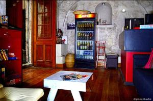 a room with a refrigerator filled with bottles of alcohol at Bubamara Bolivar in Arequipa