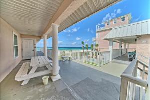 a porch with a bench and a building and the ocean at Pineapple Villas in Panama City Beach