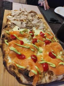 a pizza sitting on top of a wooden cutting board at Locanda LaRotonda in Villa Verucchio