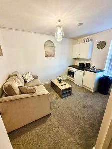 a living room with a couch and a kitchen at Elegant 1-BR Flat Roman Road in Middlesbrough