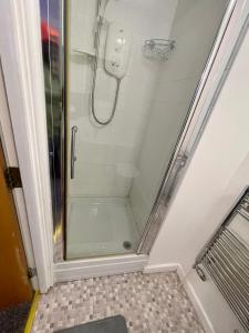 a shower with a glass door in a bathroom at Elegant 1-BR Flat Roman Road in Middlesbrough +4 photos
