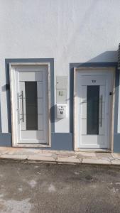 two doors on the side of a building at Charm studio in Bombarral