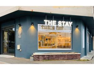 a blue building with a sign that reads the stay at THE STAY WAKKANAI - Vacation STAY 40729v in Wakkanai