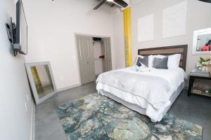 a bedroom with a large bed and a television at Cozy Luxurious Loft in Downtown Memphis in Memphis