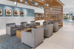 a waiting area with chairs and tables in a lobby at Sheraton Vistana Resort Villas, Lake Buena Vista Orlando in Orlando