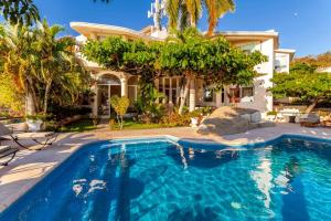 uma casa com piscina em frente a uma casa em Preciosa Villa en Marina Las Brisas em Acapulco