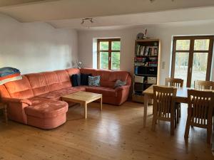 a living room with a couch and a table at Chalupa Ostrůvek in Tachov