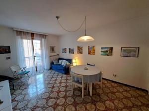 a living room with a table and a blue couch at Green House Olivedo in Varenna