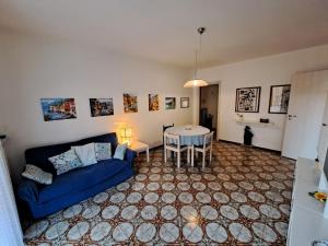 a living room with a blue couch and a table at Green House Olivedo in Varenna +15 photos