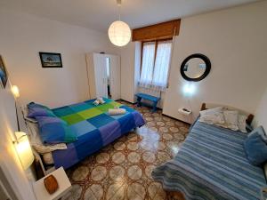 a bedroom with two beds and a mirror at Green House Olivedo in Varenna