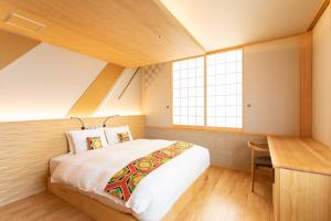 a bedroom with a large bed and a desk at Higashiyama Hills - Vacation STAY 41300v in Kyoto