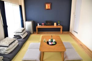 a living room with a coffee table and a couch at YūshukuFushimi Inari - Vacation STAY 41351v in Kyoto