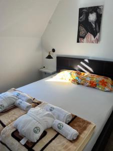 a bedroom with a bed with towels on it at Sunčani vrhovi in Raška +52 photos