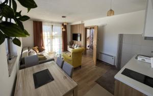 a living room with a couch and a table at Sunčani vrhovi in Raška