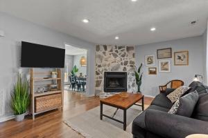 a living room with a couch and a fireplace at Beautifully updated home! Near downtown & NC State in Raleigh