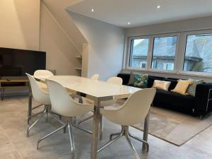 a dining room with a table and chairs and a couch at Two bedrooms in Limpertsberg with Free Parking in Luxembourg