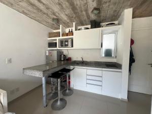 a kitchen with white cabinets and a counter top at Arenas Garzón A 8 in José Ignacio