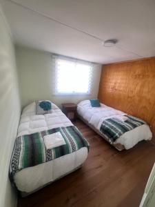 Un pat sau paturi într-o cameră la Tierra Verde