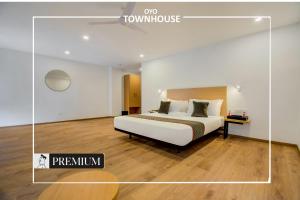 a hotel room with a bed and a desk at Townhouse 165 Netaji Road in Ahmedabad