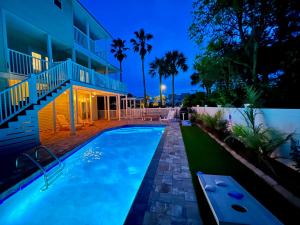 a swimming pool in front of a house at night at Caribbean Breeze in Seacrest