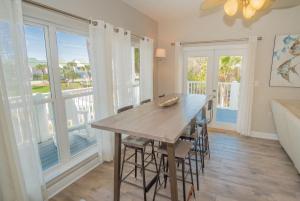 a dining room with a table and some windows at Caribbean Breeze in Seacrest