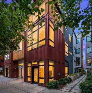 a tall red building with many windows at West Seattle's Modern Townhome in Seattle