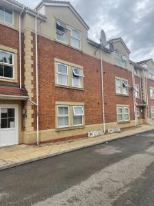 a brick building with a lot of windows on a street at Elegant 1-BR Flat Roman Road in Middlesbrough