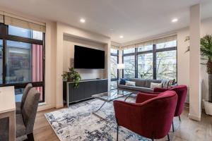 a living room with a couch and a tv at West Seattle's Modern Townhome in Seattle