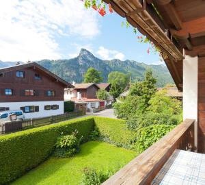 a view from the balcony of a house with a green hedge at Gästehaus Eder Oberammergau in Oberammergau