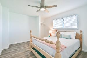 a bedroom with a bed and a ceiling fan at Baca Beach Escape II in Galveston