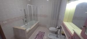 a bathroom with a shower and a toilet and a sink at La Casa Di Giorgia in Pozzuoli