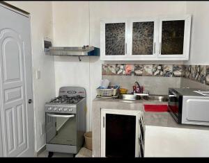 a kitchen with a stove and a sink at Apartamento la familia 2 in Santa Bárbara de Samaná