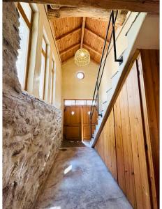 a hallway with a staircase in a building with a ceiling at Подковите in Karlovo