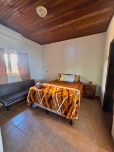 a bedroom with a bed and a couch at Sunset Views Apartment, West End in West End