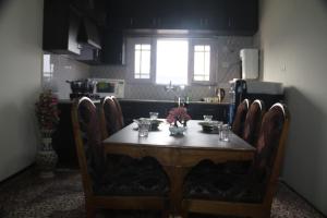 a table in a kitchen with a table and chairs at Baba BabaBah in Srinagar