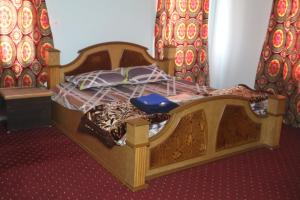 a bedroom with a wooden bed in a room at Baba BabaBah in Srinagar