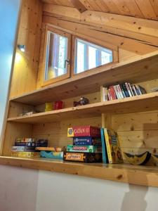 a wooden shelf in a room with books at Chalet d'architecte-Alpe d'Huez 9p- 4ch- 1bureau in Villard-Reculas