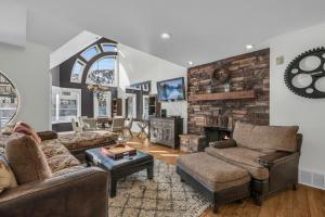 a living room with a couch and a fireplace at Roomy 4BR Townhome Near Main St with Private Hot Tub in Park City