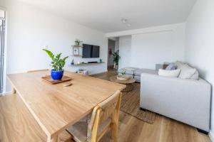 a living room with a table and a couch at Greenpoint Emerald in Cape Town