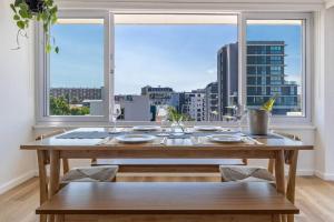 a wooden table in a room with a large window at Greenpoint Emerald in Cape Town