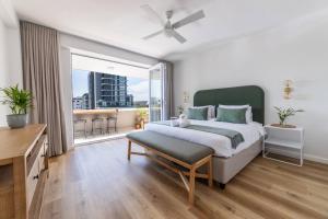 a bedroom with a large bed and a large window at Greenpoint Emerald in Cape Town