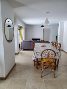 a dining room with a table and chairs and a mirror at Relais du lac de la Truyère in Anglards-de-Saint-Flour