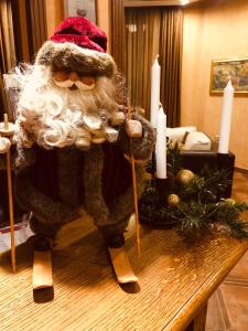a santa claus figurine on a table with candles at Evelina Palace Hotel in Bansko