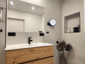 a bathroom with a sink and a mirror at Ferienwohnung Ott in Bad Endorf +14 photos