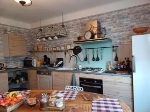 a kitchen with a table with fruits and vegetables on it at Chambresdhoteslaforet com in Longwy