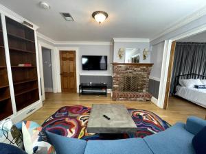 a living room with a blue couch and a fireplace at Stupendous Apartment Steps From the Capitol! in Washington, D.C.