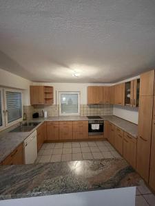 an empty kitchen with wooden cabinets and a ceiling at Diti Apartment in Lottstetten +13 photos