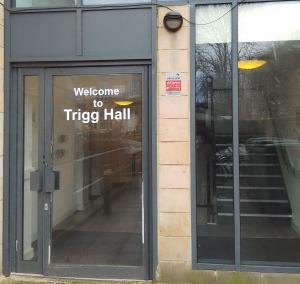 a welcome to trike hall sign on the door of a building at Trigg Hall in Bradford