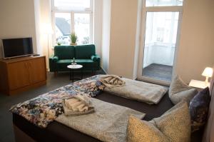 a living room with a couch and a chair at Hotel Villa Elisabeth in Ostseebad Sellin